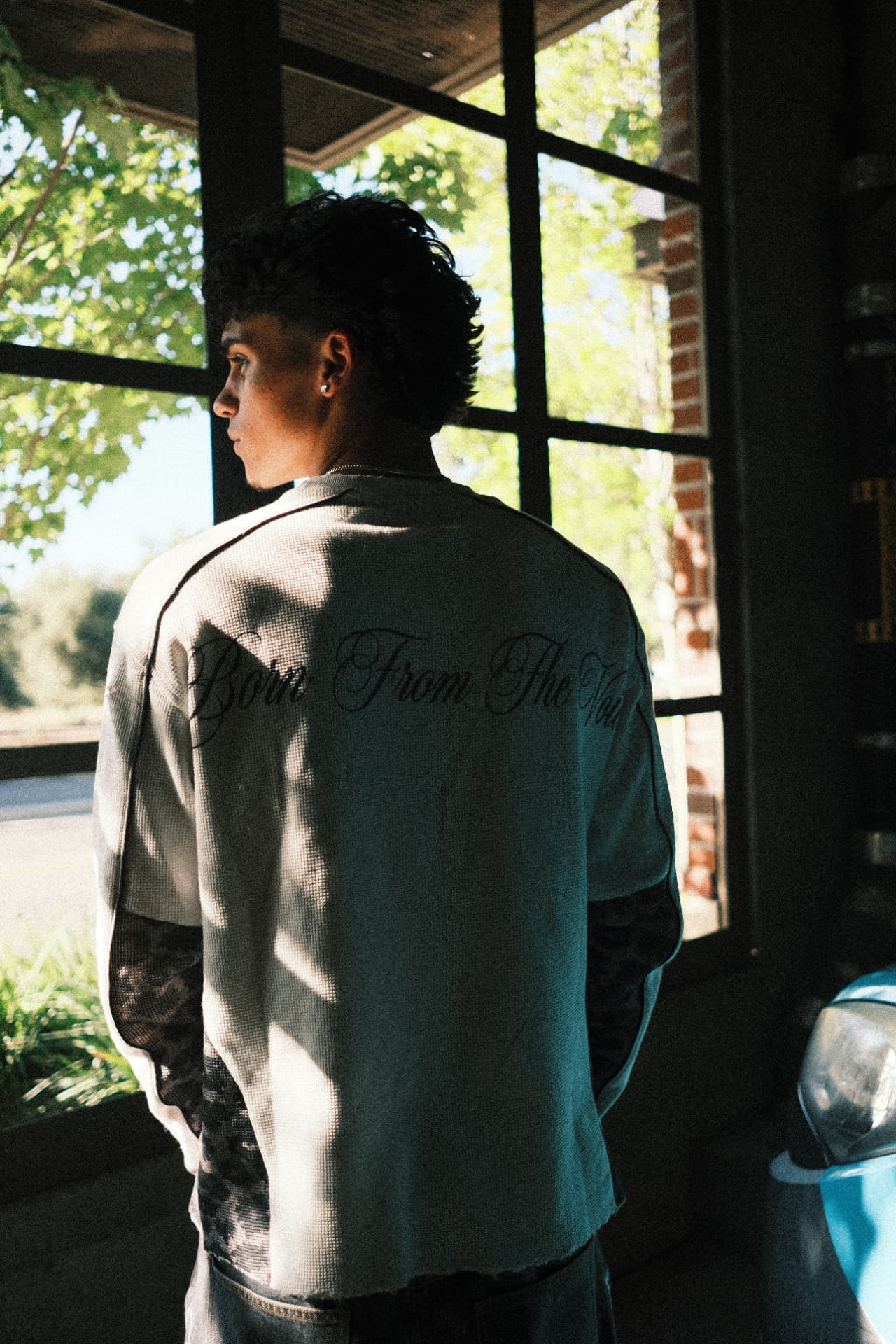 Born From The Void lettering on the back of a thermal by the window
