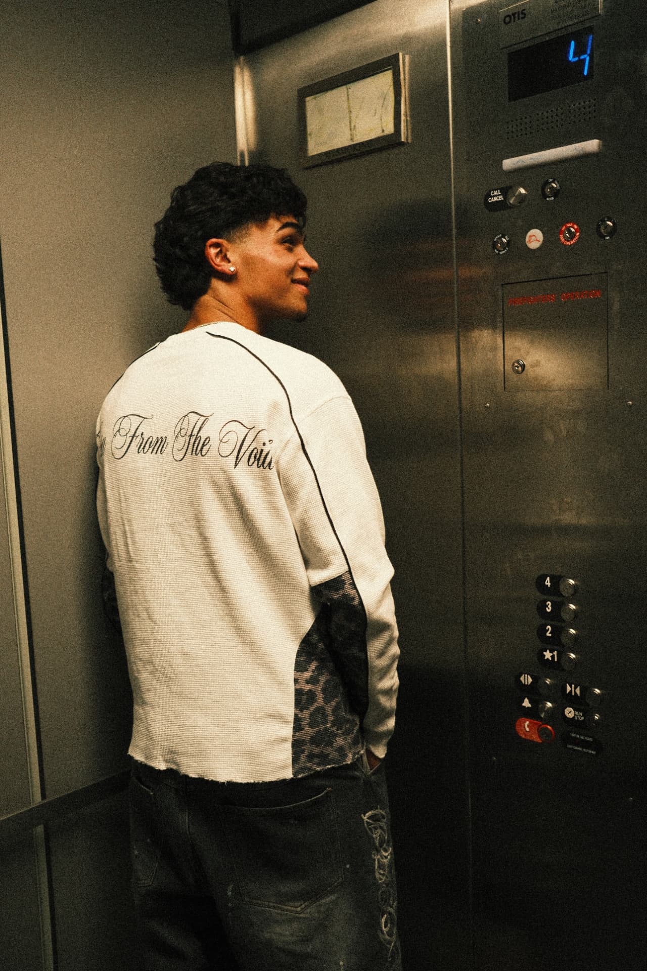 Back view of the Voidborn white thermal in an elevator