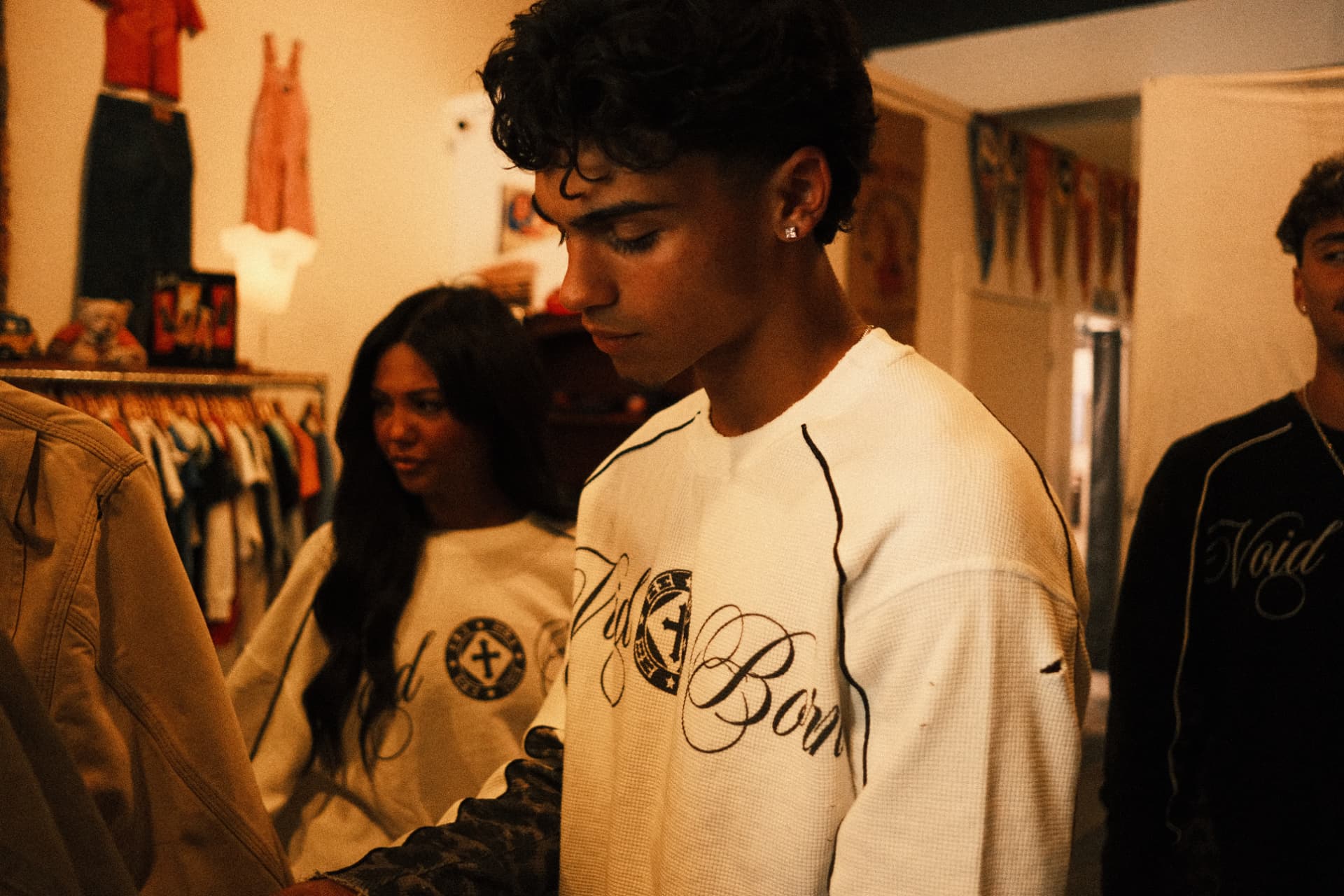 Voidborn white and black thermals worn together in a clothing shop